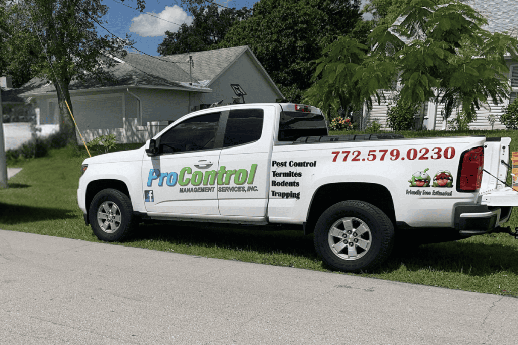 A white pickup truck is parked on a residential street, displaying the logo and contact information for "Pro Control Management Services, Inc." on its side. The truck highlights their pest control services, including termite control, rodents, and trapping. Contact number: 772-271-5465.