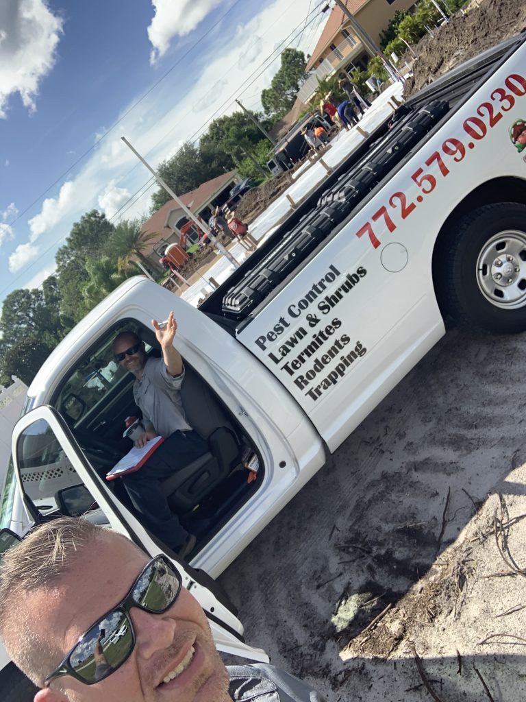 About Us: A man sitting in the back of a white truck.