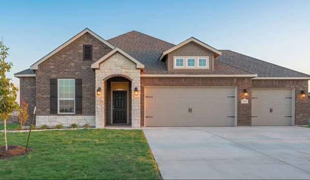 A modern single-story brick house with a dark front door, arched entryway, three-car garage, and well-kept lawn under a clear blue sky reflects the quality homes featured in our About Us story.